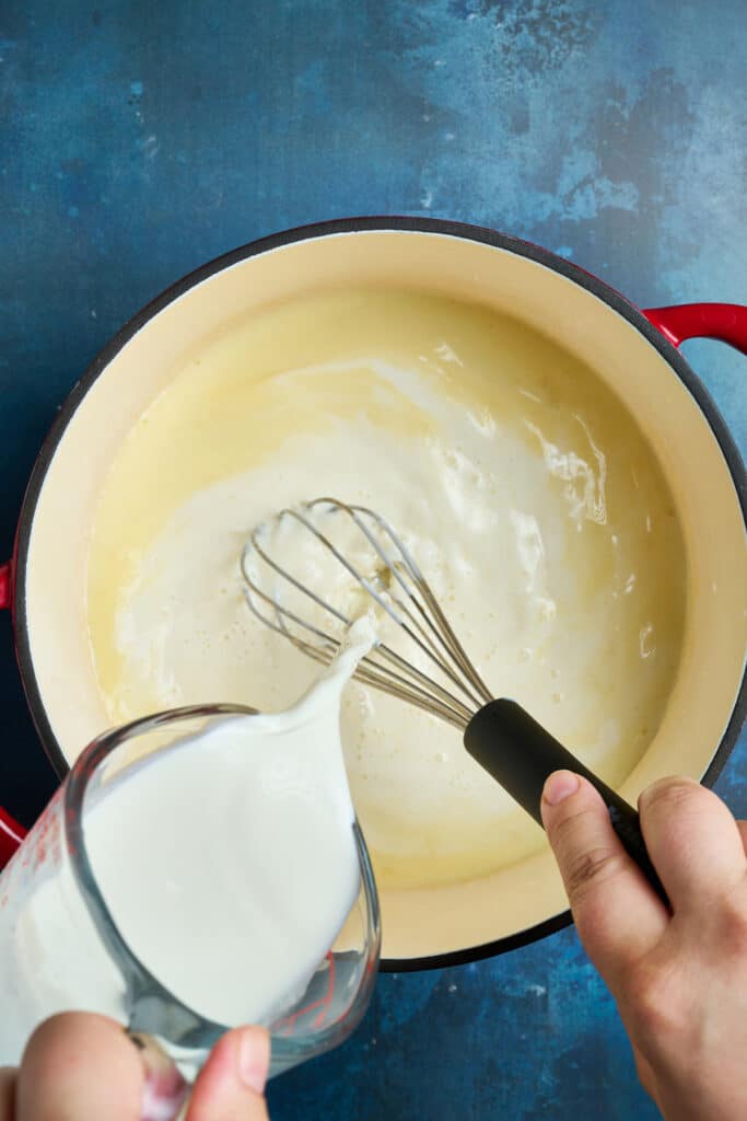 Pouring milk into a rough in a pot