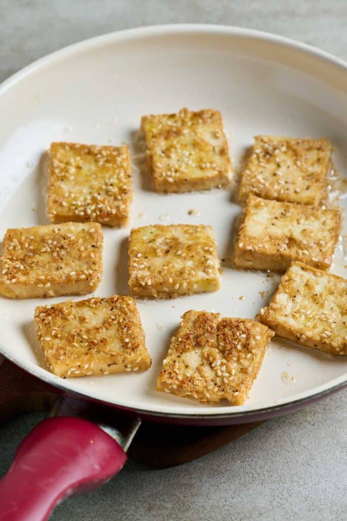 Pan frying tofu in a skillet