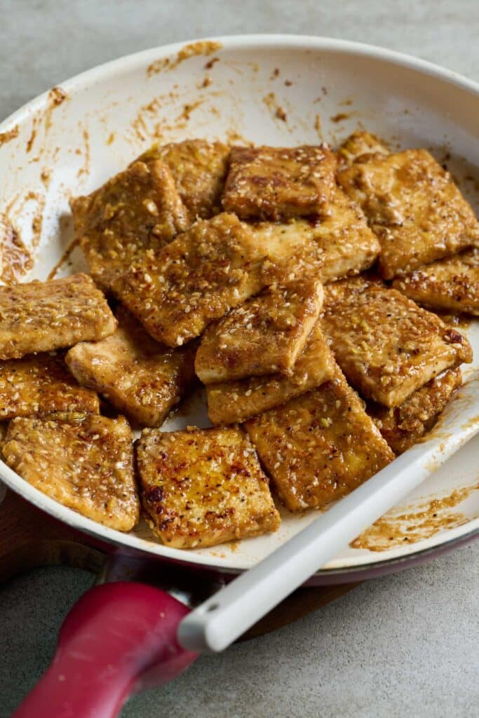 Crispy tofu pieces tossed with tahini-lemon pepper glaze.