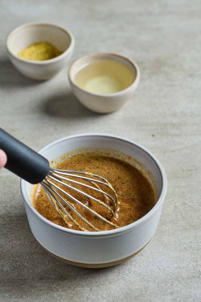 Mixing marinade ingredients into a small bowl