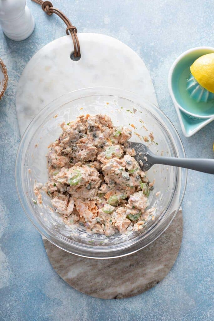 A glass bowl with a creamy salmon salad