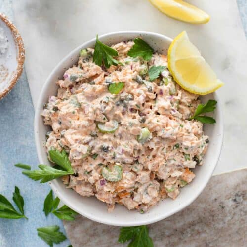 salmon salad garnished with lemons and parsley