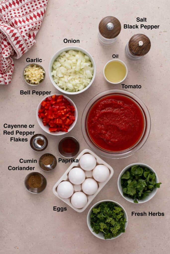 Ingredients to make eggs poached in tomato sauce