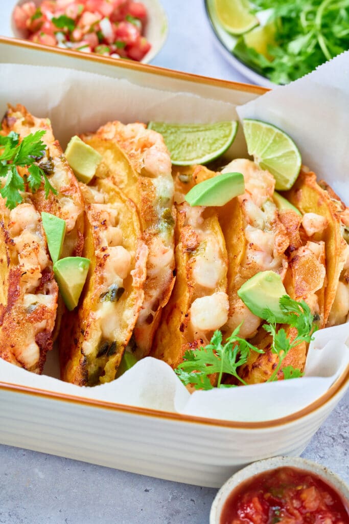 Crispy and cheesy tacos on a serving dish