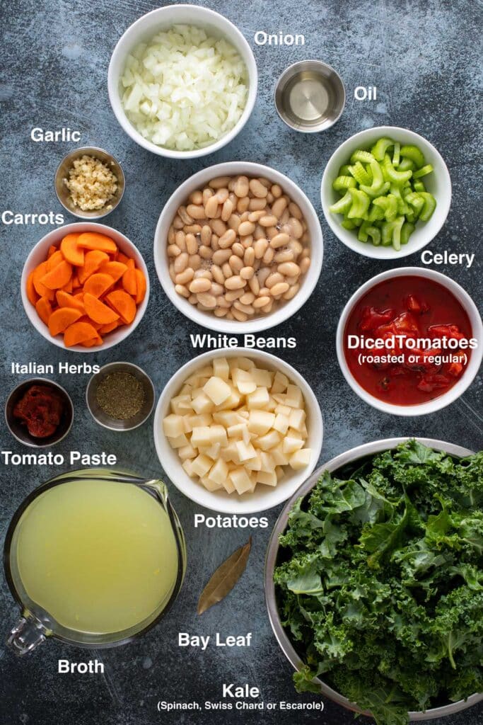 Ingredients to make White Bean and tomato soup with heart greens sitting on a counter.