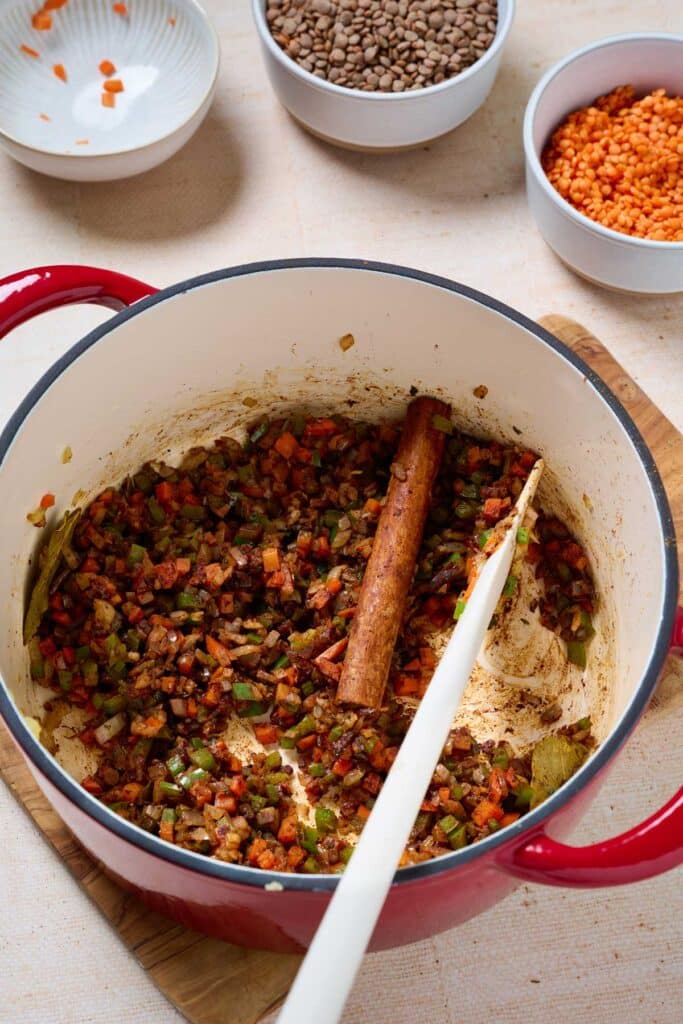 Spices blooming in a pot with sautéed veggies.