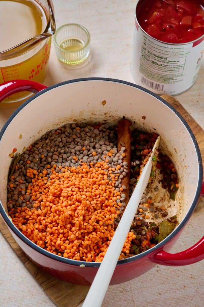 Brown and red lentils with veggies and spices in a pot