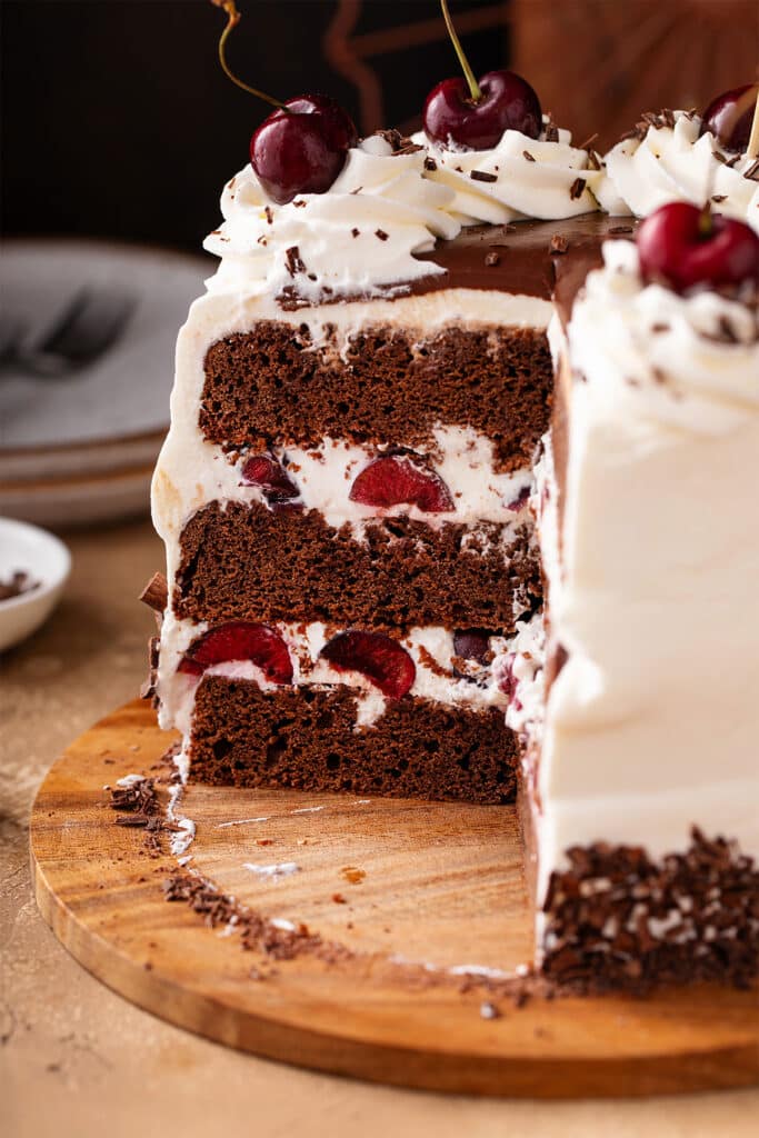Black Forest Cake cut to show the three layers of chocolate cake, whipped cream and cherries