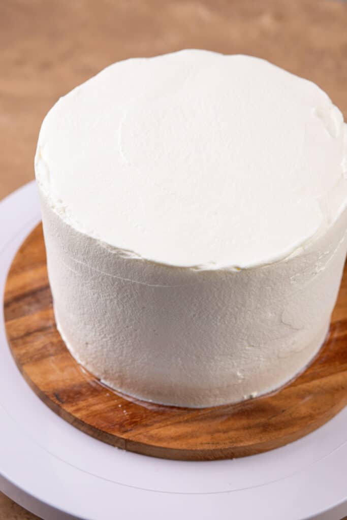 A layered caked covered in whipped frosting