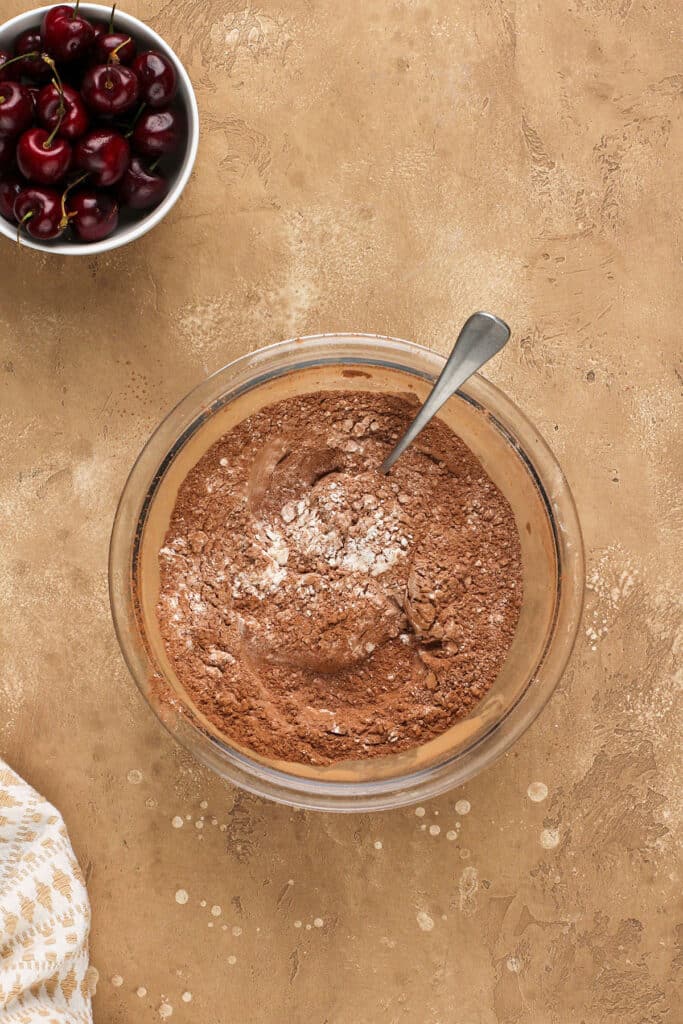 Dry cake ingredients mixed in a glass bowl