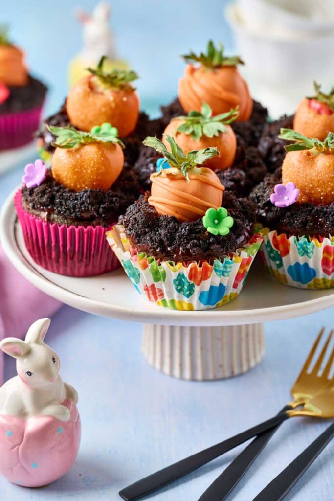 Festive Easter cupcakes with chocolate covered strawberries on a cake platter