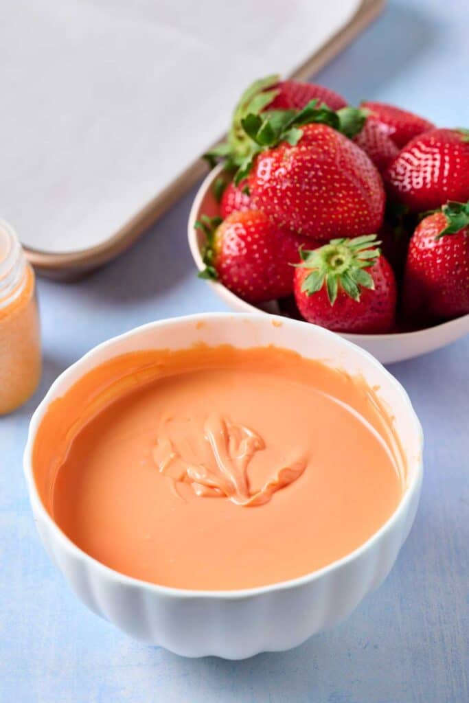 Melted orange candy melts in a bowl