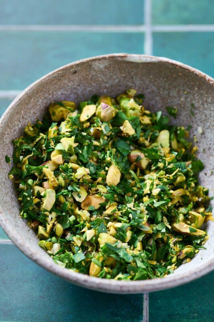 A bowl with fresh herb, garlic and citrus zest gremolata