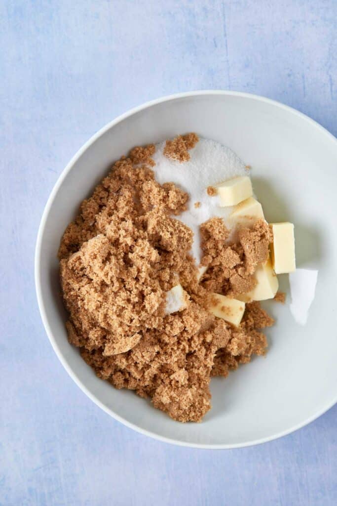 Combining brown and granulated sugar with butter in a mixing bowl