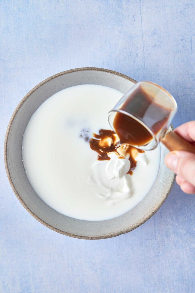 Combining brewed coffee and buttermilk in a bowl