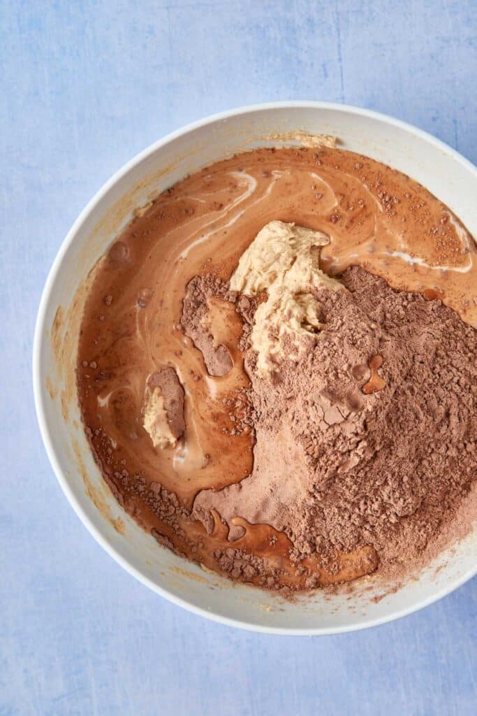 Combining wet and dry cake ingredients in a bowl