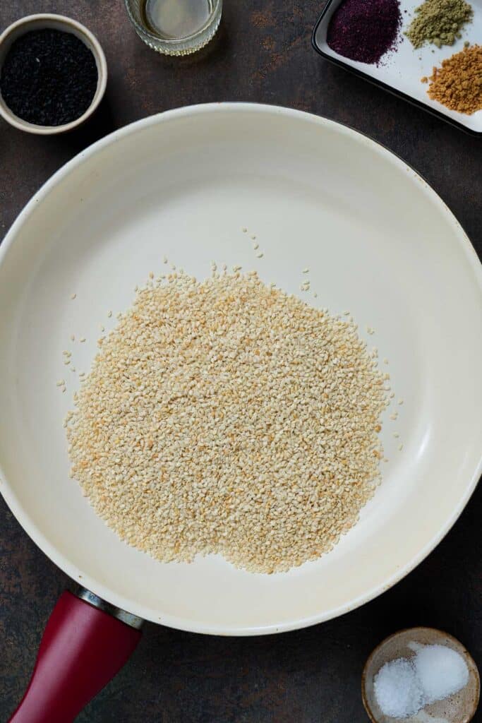 A dry skillet with sesame seeds