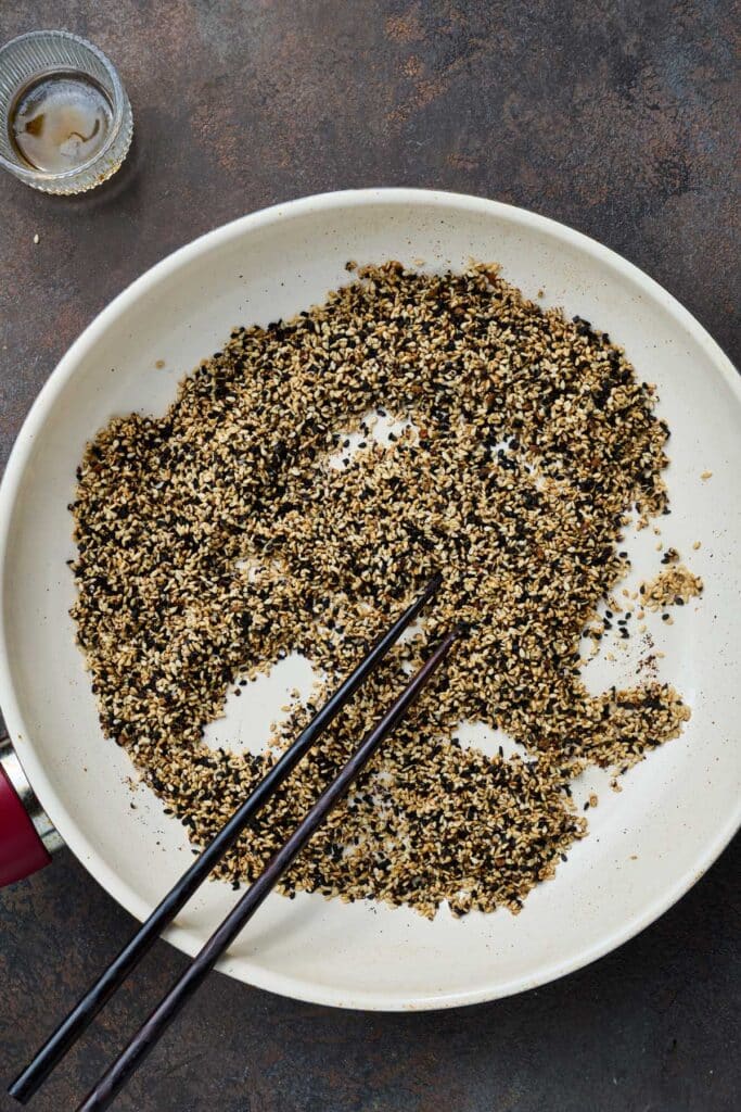 Sesame seeds and seasonings in a dry skillet