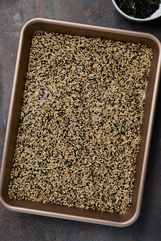 Cooling sesame seeds and seasoning on a sheet pan