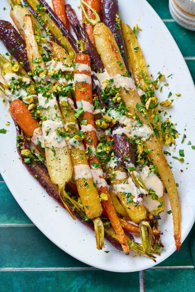 Roasted carrots topped with fresh herb gremolata and drizzled with tahini sauce.