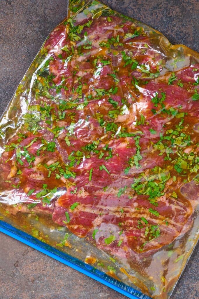 Skirt steak marinating in a resealable bag