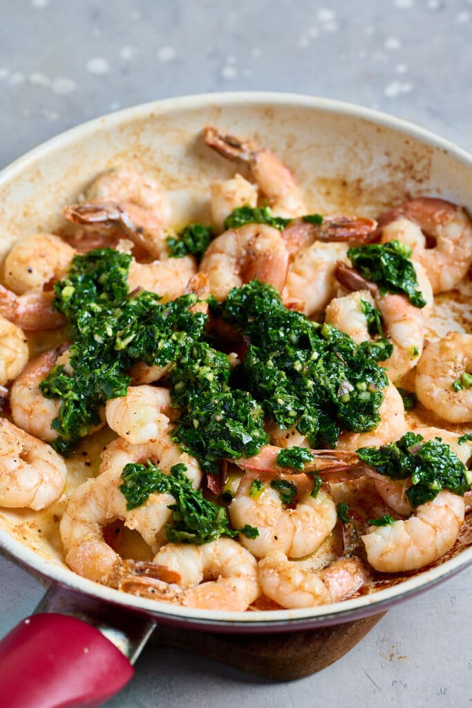 Sautéed shrimp with spoonfuls of herby Argentinian chimichurri