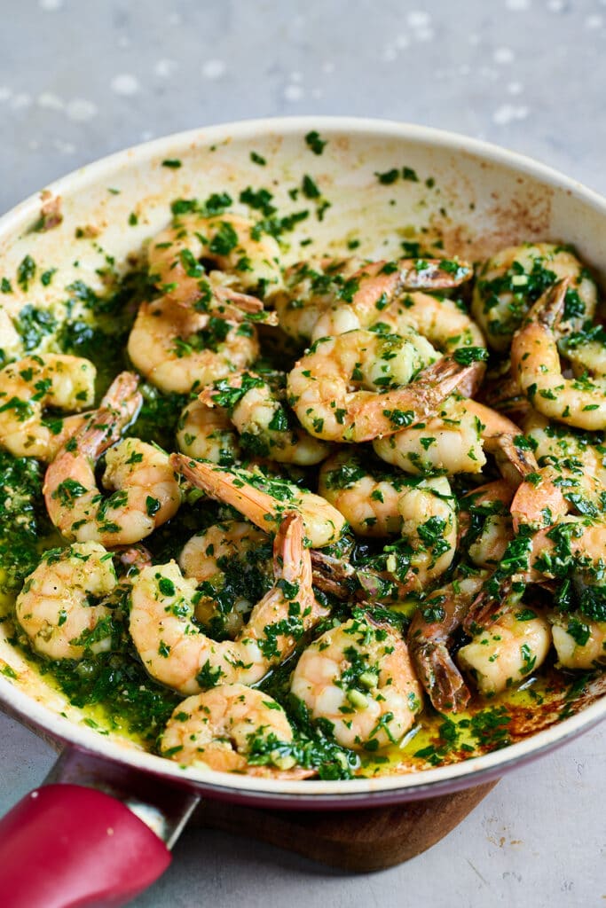 Sautéed shrimp tossed with chimichurri sauce in a sauté pan