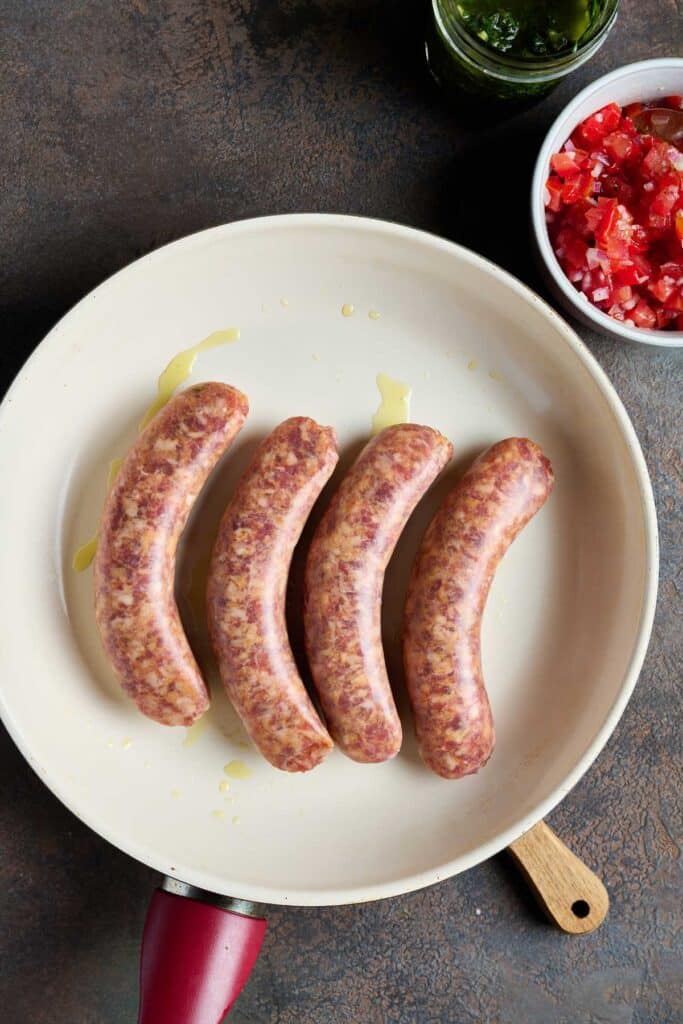 Fresh sausage getting cooked in a skillet