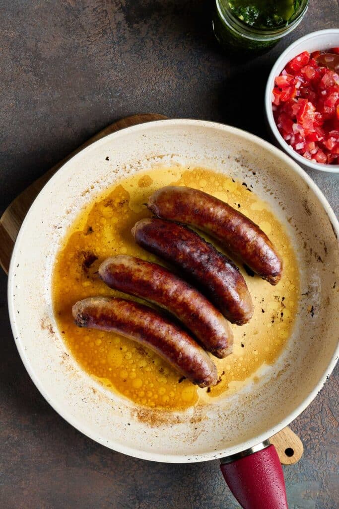 Cooked sausages (chorizo) in a skillet