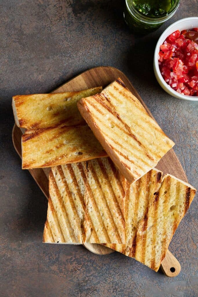 Perfectly golden brown grilled bread on a cutting board