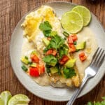 creamy enchilada with sauce and melted cheese topped with chopped pico