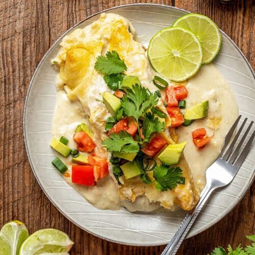 creamy enchilada with sauce and melted cheese topped with chopped pico