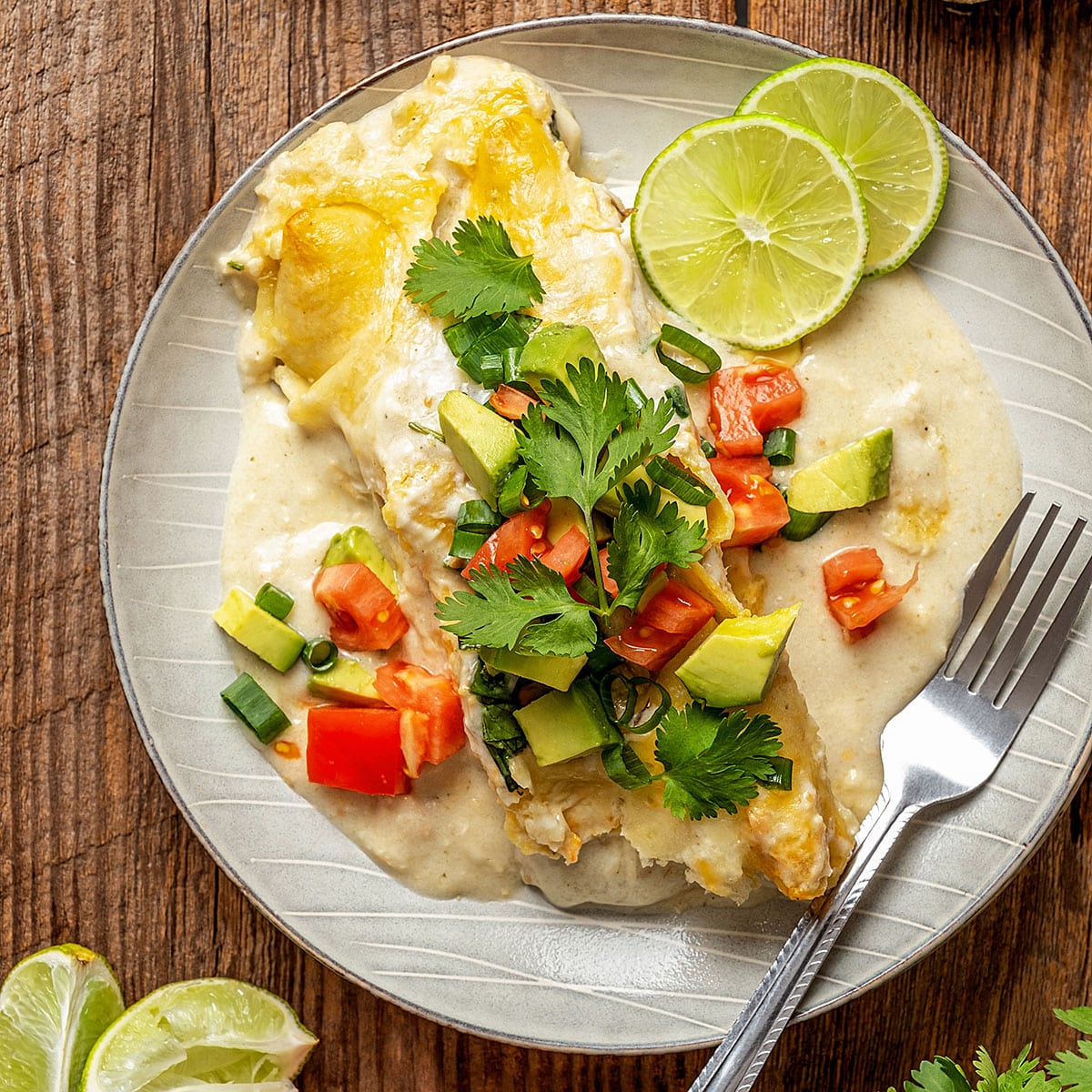 creamy enchilada with sauce and melted cheese topped with chopped pico