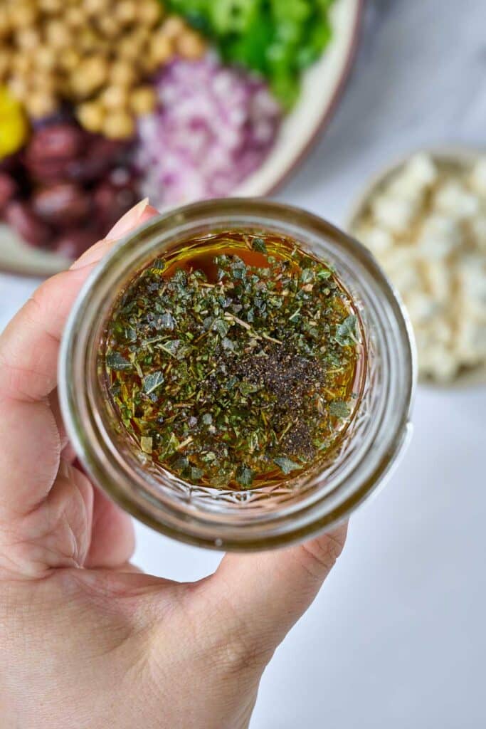 Greek-style salad dressing ingredients in a jar