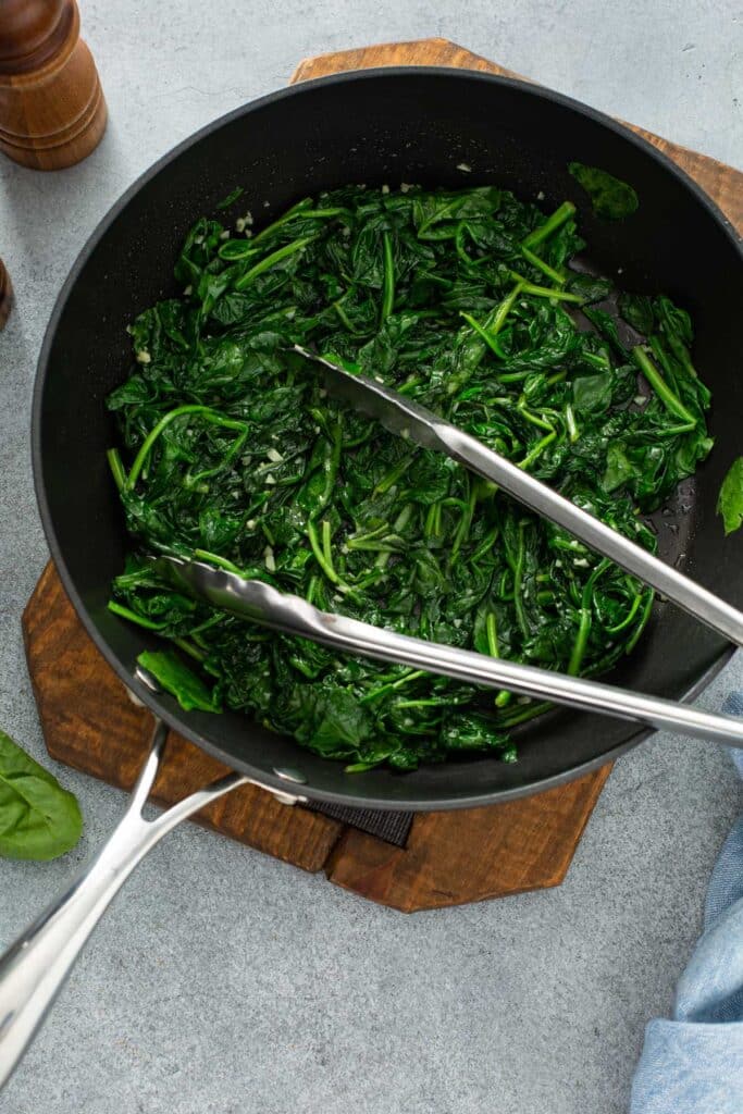 Wilted baby spinach in a skillet