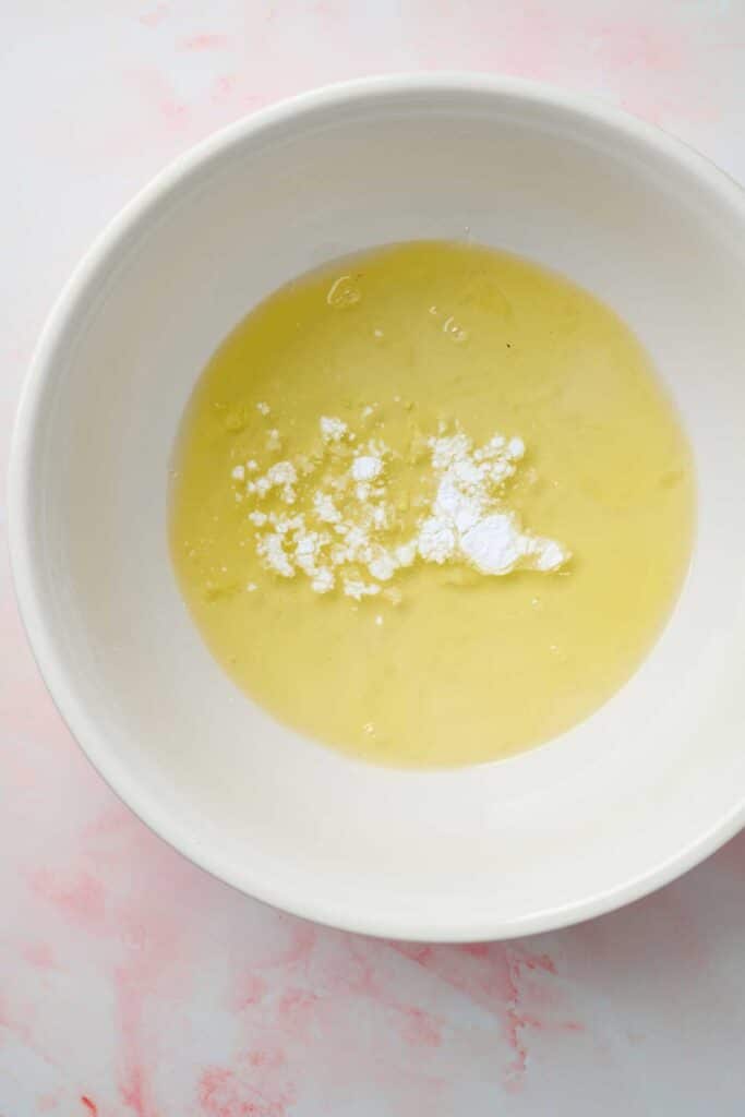 Egg whites and cream of tartar in a large mixing bowl