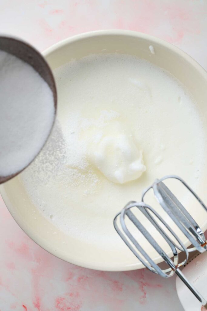 Adding sugar to soft whipped egg whites