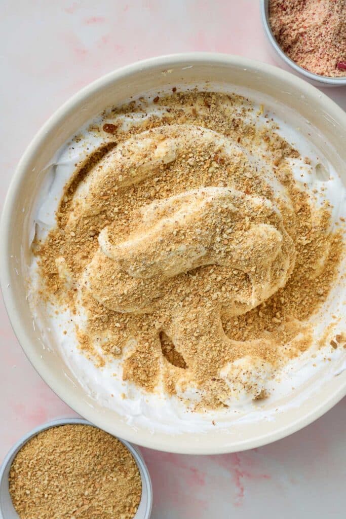 Egg whites whipped to stiff peaks topped with crushed Maria cookies and finely chopped nuts