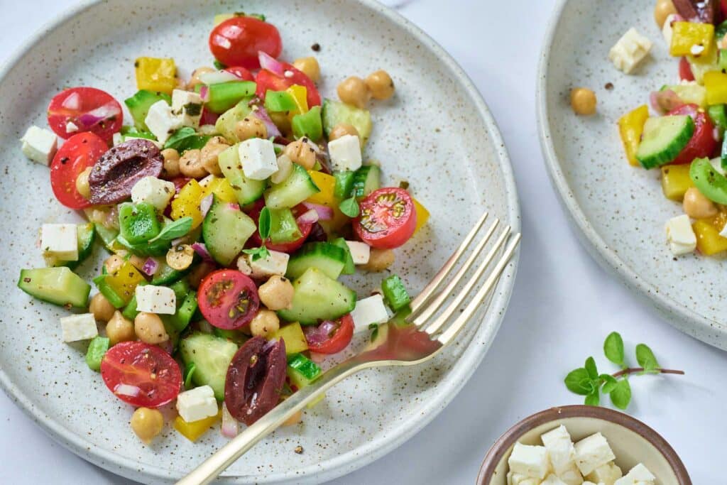 Plates with chopped Mediterranean salad