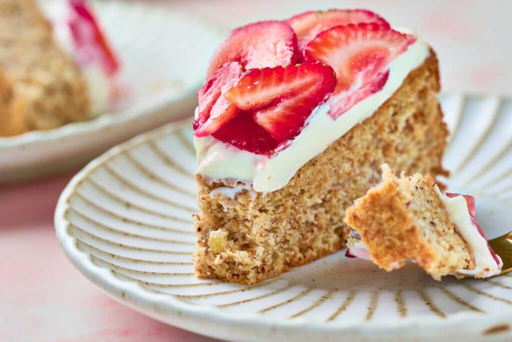 A slice of strawberry meringue cake Mostachon on a plate