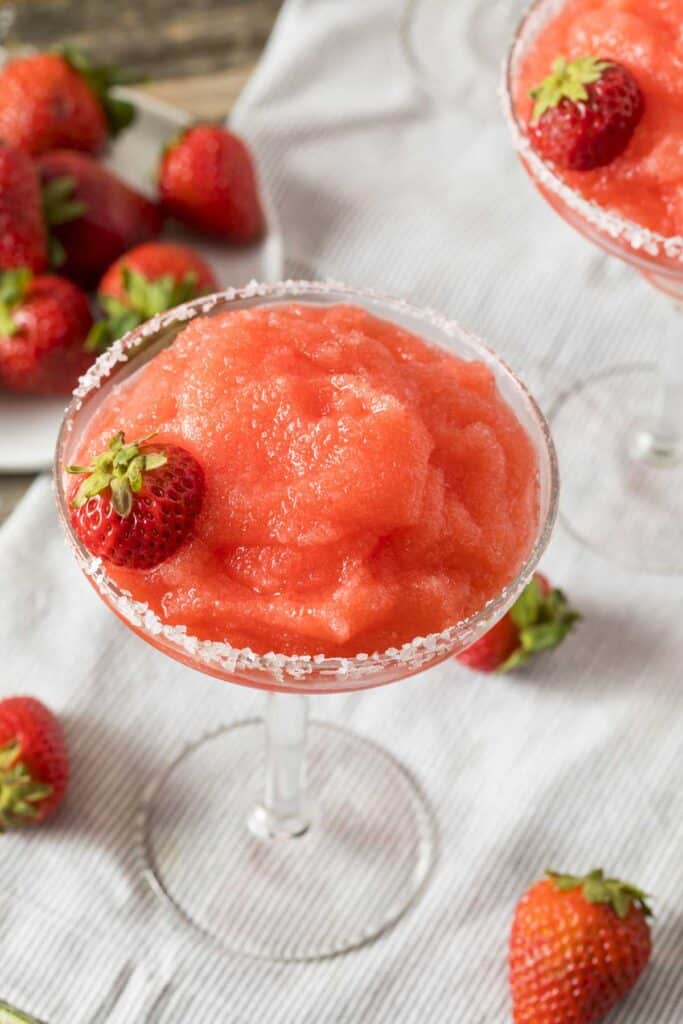 salt-rimmed glass with frozen strawberry margarita