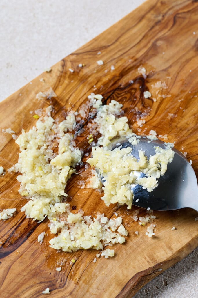 Garlic and salt paste made on a cutting board
