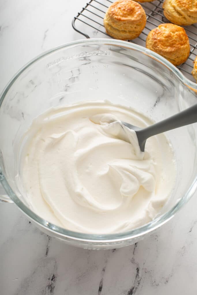 Homemade whipped cream in a glass bowl