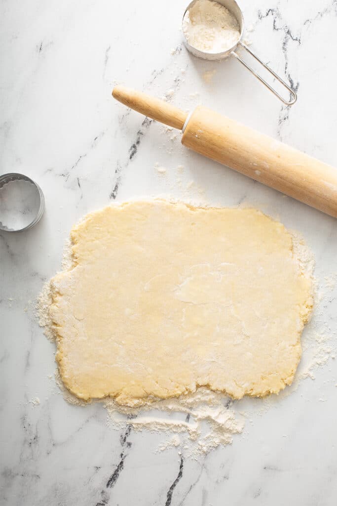Roll out biscuit dough in a lightly floured surface