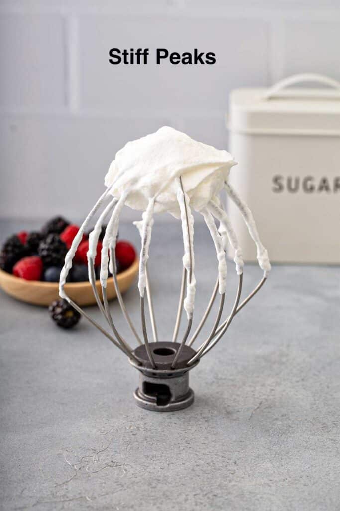 Homemade whipped cream at stiff peaks on a whisk attachment