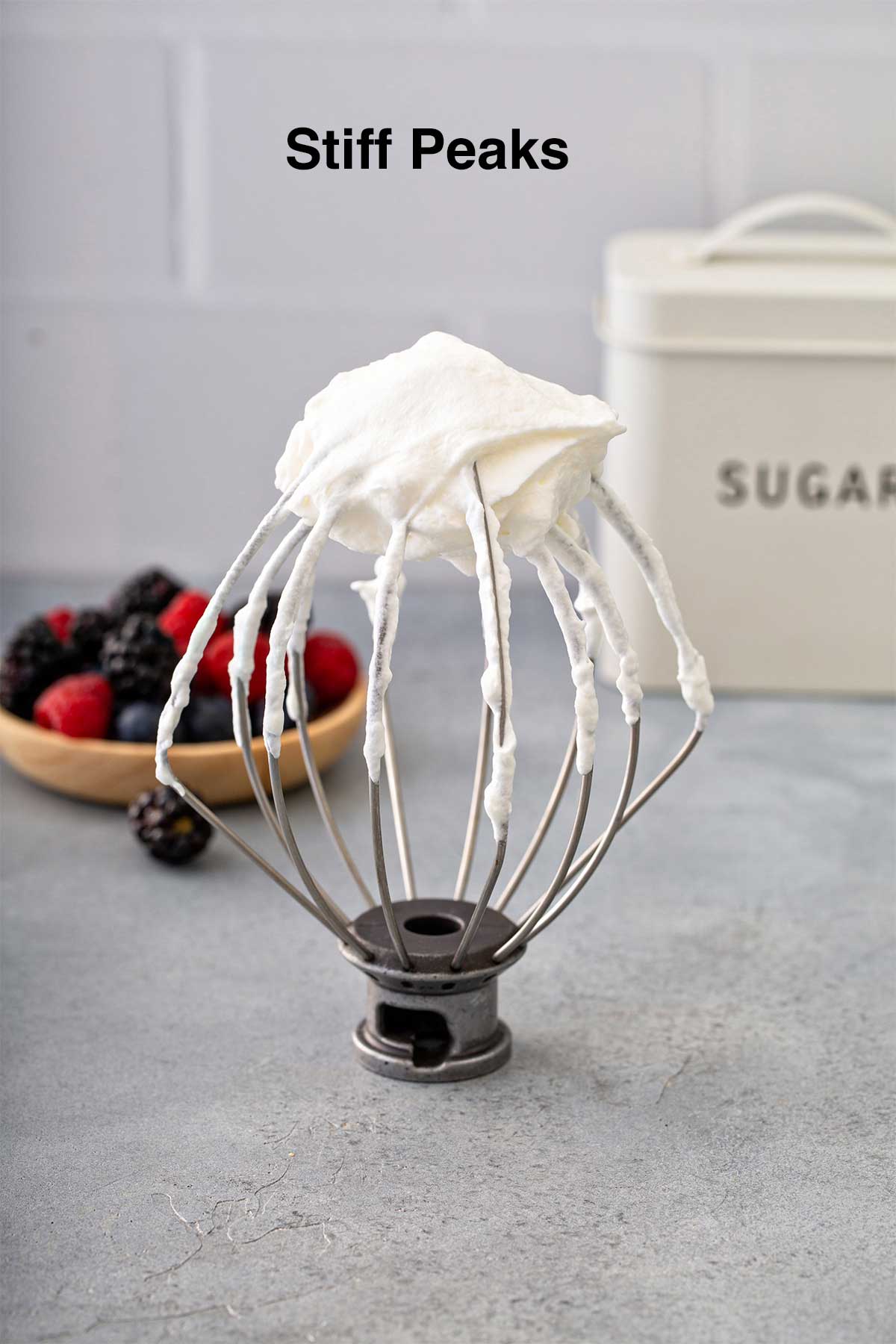 Homemade whipped cream at stiff peaks on a whisk attachment