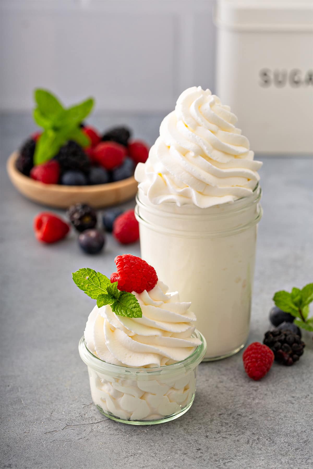 Fresh homemade whipped cream piped into a glass jar