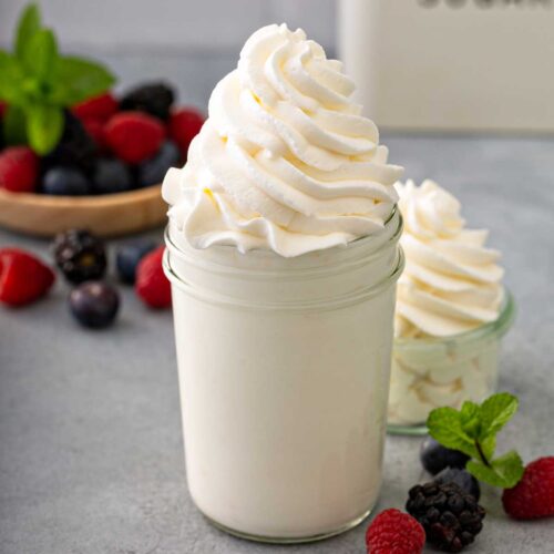 light and fluffy homemade whipped cream pipped in a glass jar