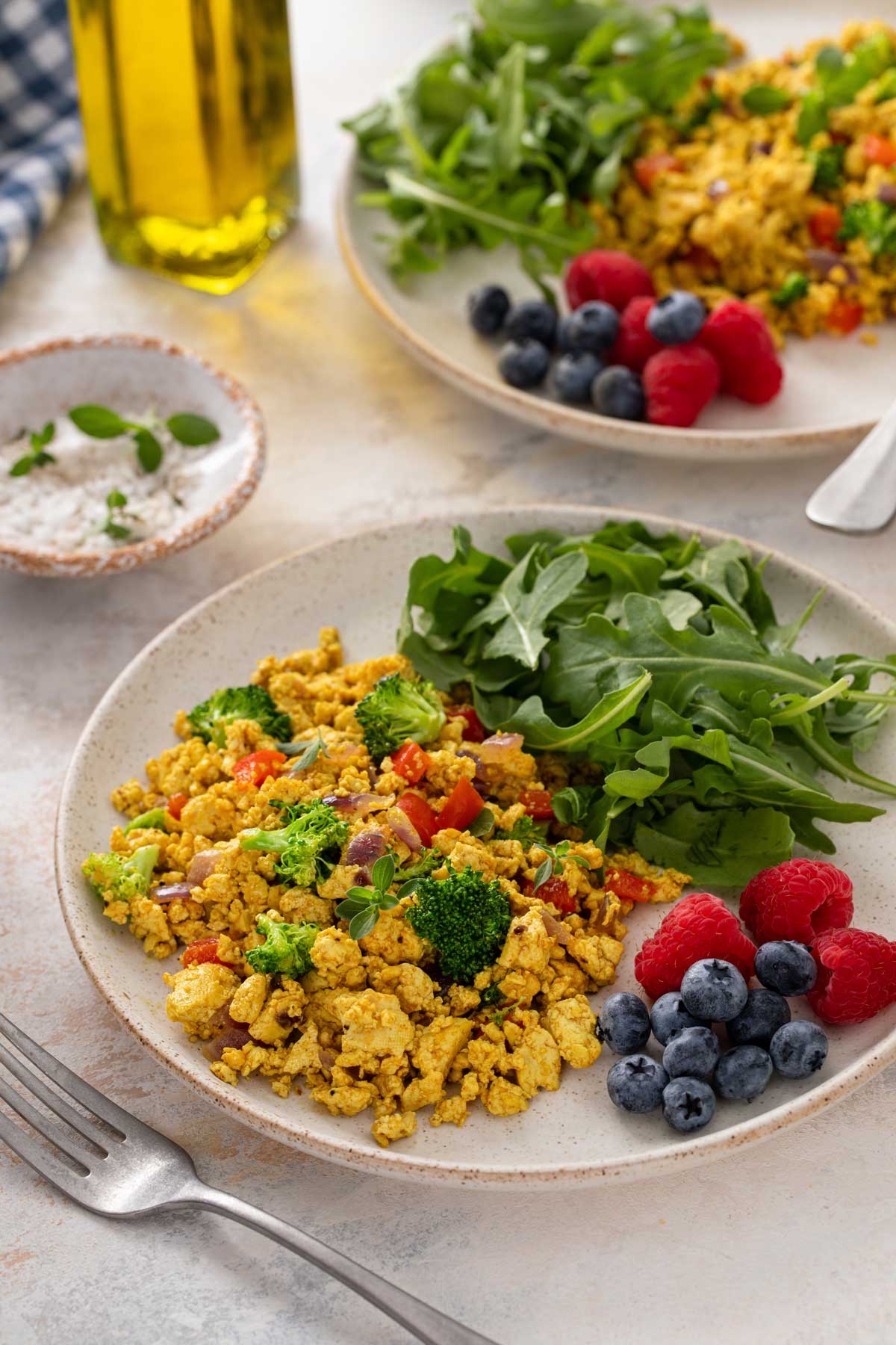 Tofu scramble served with arugula, raspberries and blueberries