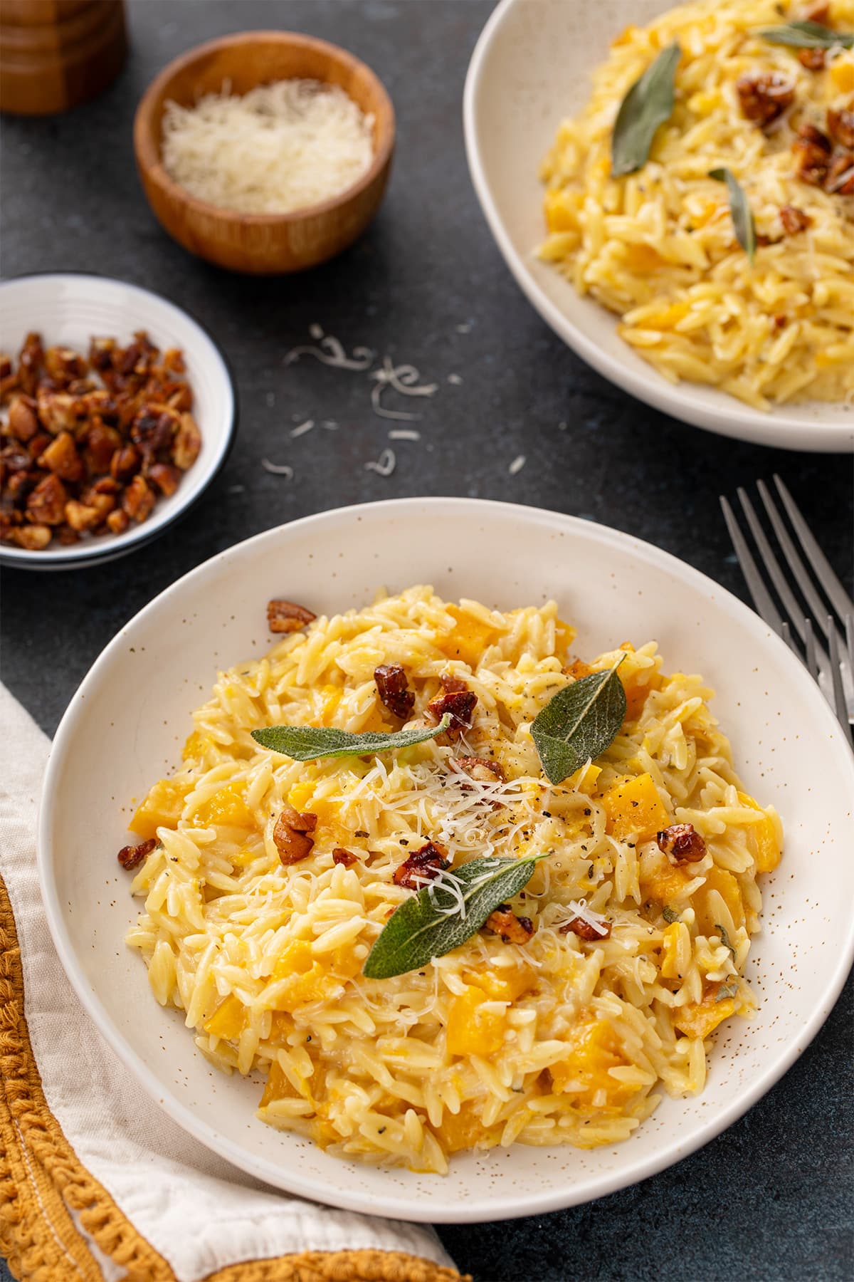 Brown butter butternut squash orzo topped with Parmesan, sage and candied pecans.